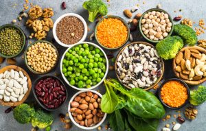 a table full of bowls of plant and legumes.