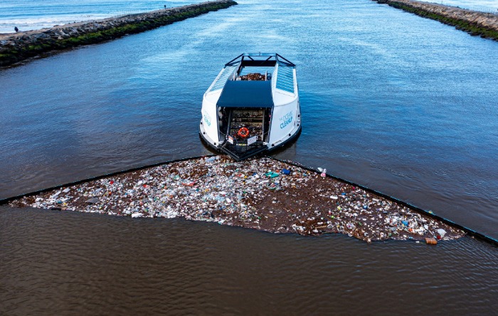 Boat cleans a river by collecting plastic